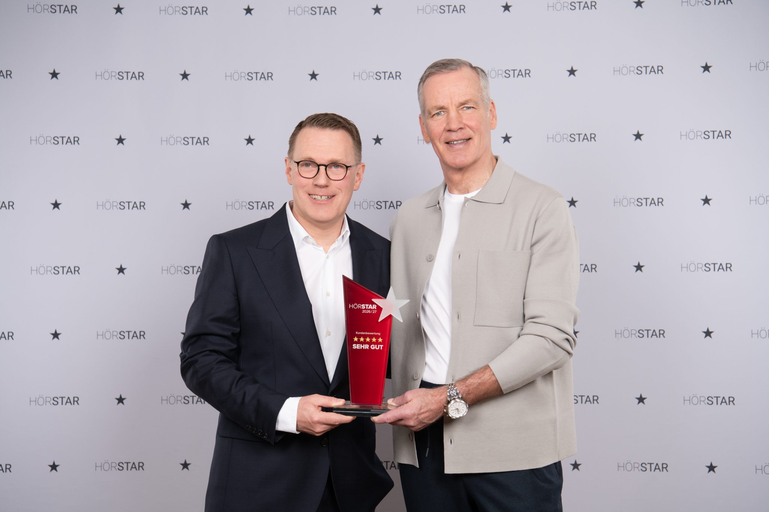 Herr Schirner und seine Mitarbeiterinnen nehmen den Preis zum TOP100 Akusiker 2025/2026 entgegen.